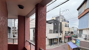 A balcony with a view of a street and buildings. - High-quality Japanese modern private accommodation! Experience staying in a shopping district! Japanese/Western style room & bed! Good access to Disney! Free parking! (Shimoshinozakimachi, Edogawa City)