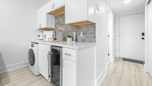 A modern kitchen with white cabinetry, a built-in oven, and a microwave. - Golf Course Views | Upscale Studio | Wesley Chapel | Sleeps 2, Pickleball Included | Saddlebrook (Zephyrhills)