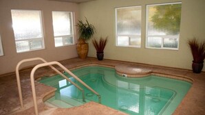 An indoor swimming pool with a built-in bench, a ladder, and potted plants. - 2 bd suite/6p in Cozy Boutique Lodge between the slopes and Lake Tahoe near all (South Lake Tahoe)