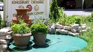 A sign for The Lodge Kingsbury Crossing with a view of a building and a parking area. - 2 bd suite/6p in Cozy Boutique Lodge between the slopes and Lake Tahoe near all (South Lake Tahoe)