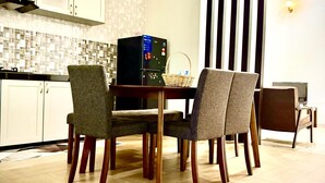 A modern kitchen with a dining area. - Homestay Selesa KBK Guesthouse (Kuala Terengganu)