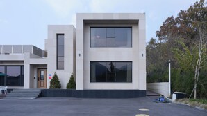 A modern building with a flat roof, large windows, and a small entrance. - laforet space (Gongju)