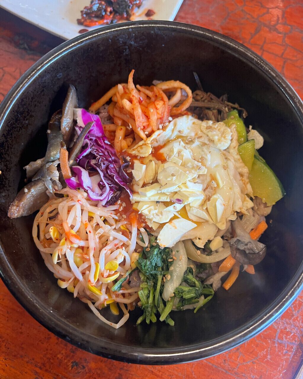 A bowl of mixed vegetables and noodles.