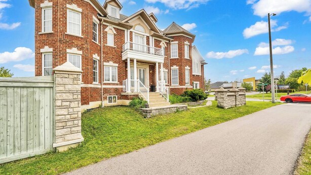 A two-story brick house with a stone foundation, a front porch, and a driveway. - 4 Tvs, King Bed, Across Recreational Park, Tennis Court, Near Commercial Center (Ajax)