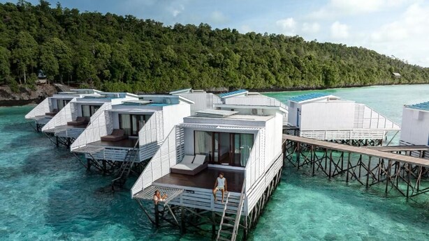 Overwater bungalows with private pools, wooden walkways, and clear turquoise water. - Arasatu Villas and Sanctuary (Maratua Island)