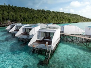 Overwater bungalows with private pools, wooden walkways, and clear turquoise water. - Arasatu Villas and Sanctuary (Maratua Island)