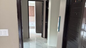 A corridor with a tiled floor, a door with the number 403, and a wall-mounted light switch. - Sitara Hotel Patong Beach (Patong)