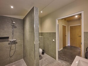 Un baño moderno con ducha, inodoro y lavabo.