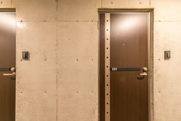 A set of double doors with a number plate indicating room 201. - The Breakfast Hotel Porto Ishigaki (Ishigaki)
