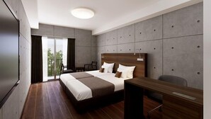 A modern hotel room with a large bed, a desk, and a view of the outdoors. - The Breakfast Hotel Porto Ishigaki (Ishigaki)