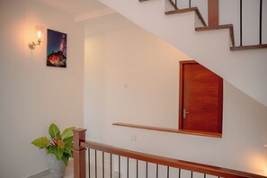 A staircase with wooden railings and a wooden door at the top.