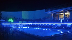 A pool area with lounge chairs and a neon sign. - Villa Israel Ecopark El Nido by Cocotel Powered by Fave (El Nido)