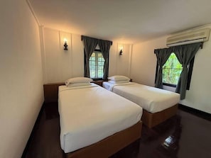 A room with two single beds, a window with curtains, an air conditioning unit, and wall-mounted lights. - Maesa Valley Garden Resort & Craft Village (Mae Rim)