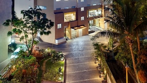 A modern hotel building with multiple floors, a well-lit entrance, and a visible sign for the Ginger Hotel. - Ginger Andheri East (Mumbai)