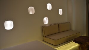 Ein modernes Zimmer mit einer Couch und eingelassener Wandbeleuchtung.