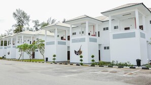 A row of white buildings with a sign reading "PAVANG 4". - The Payang Scout Hotel (Kuala Terengganu)