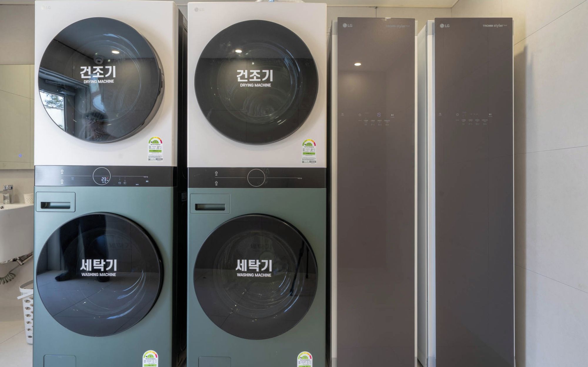 A laundry facility with two washing machines and two dryers.