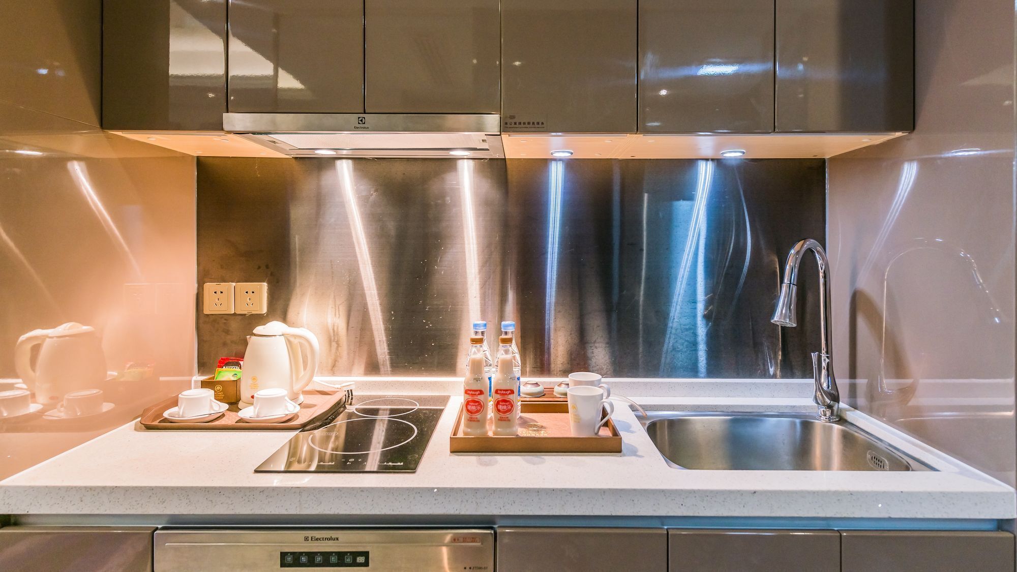 A modern kitchen with stainless steel appliances, a built-in oven, and a sink.