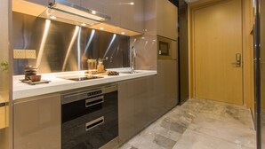 A modern kitchen with stainless steel appliances, a built-in oven, and a microwave. - Nomo Beijing Rd.jiedenga-mall Apartment (Guangzhou)