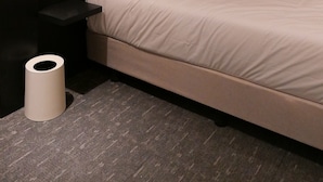 A modern hotel room with a large bed, a bedside table, a wall-mounted light, and a curtain. - Nesto Hongdae (Seoul)