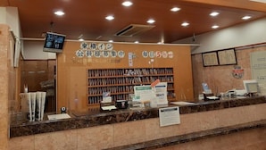 A reception area with a 'FRONT' sign, a digital display, and a counter with various items. - Toyoko Inn Tokyo Yamanote-sen Otsuka-eki Kita-guchi No.2 (Tokyo)