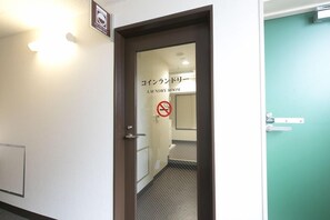A hotel room entrance with a sign indicating a laundry room. - R B Hotel Kyoto Eki Hachijoguchi (Kyoto)