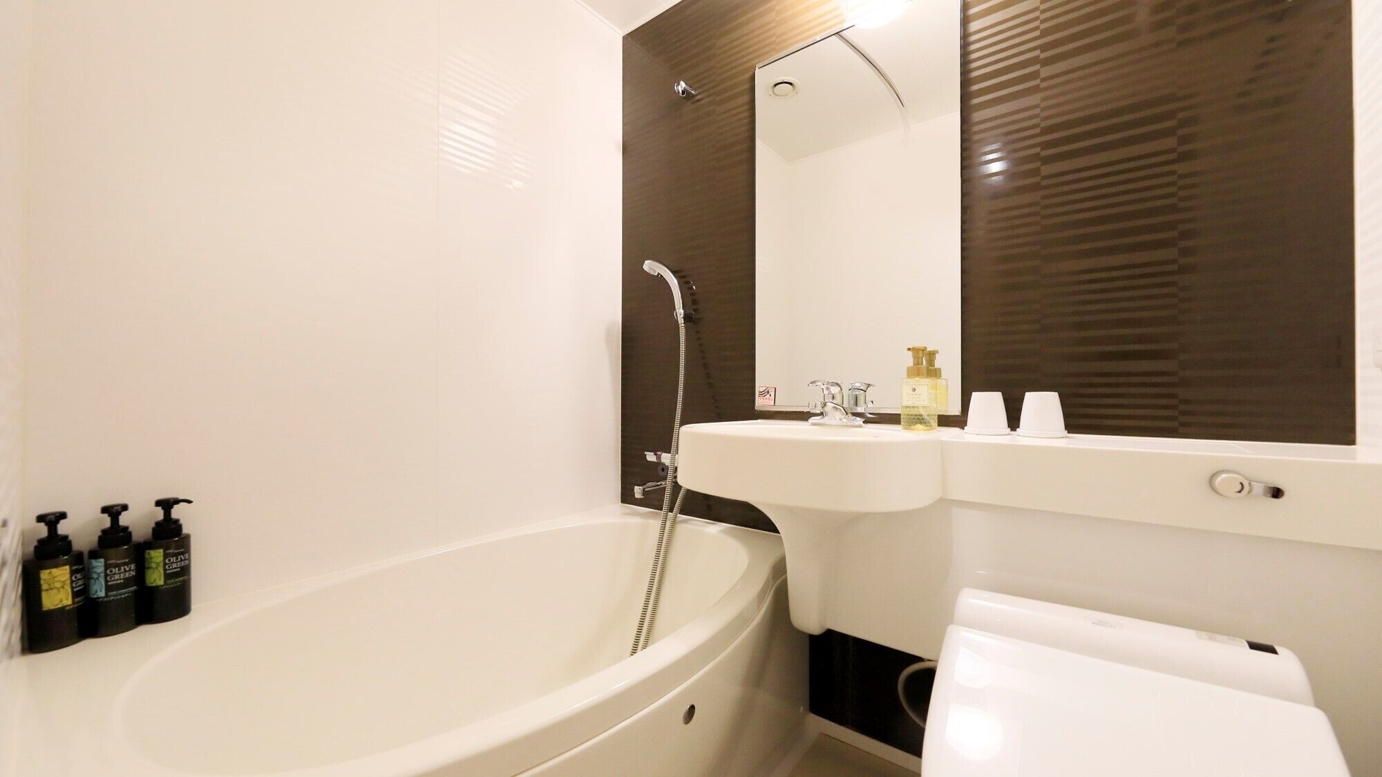A modern bathroom with a freestanding bathtub, a sink, and a mirror.