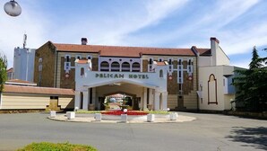The Delican Hotel with a central entrance, a tiled roof, and a landscaped garden area. - Duni Royal Resort - Hotel Pelican (Sozopol)