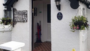 Ein Gästehaus mit Schwarz-Weiß-Fassade, einem Schild mit der Aufschrift 'Craigbank Guest House' und einer Plakette, die es als 'Scottish Tourist House' kennzeichnet.