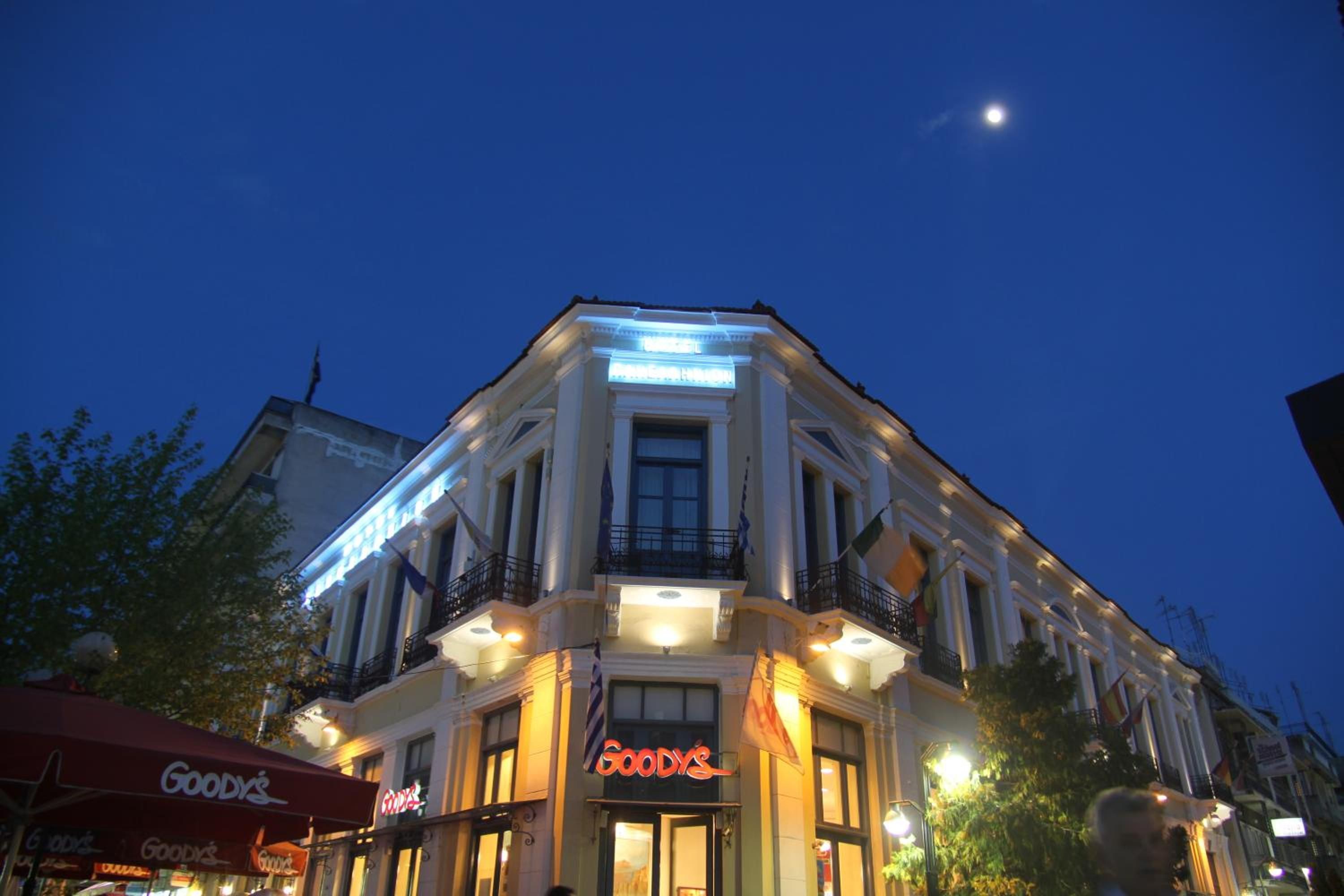 Ein Gebäude mit einem gut sichtbaren 'Goodys'-Schild, einem Balkon und einem Mond am Himmel.
