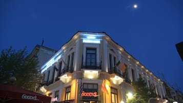 Ein Gebäude mit einem gut sichtbaren 'Goodys'-Schild, einem Balkon und einem Mond am Himmel.