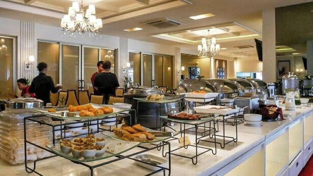 A buffet setup with various food items and a modern interior design.