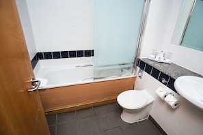 A modern bathroom with a bathtub, toilet, and sink. - Park (Kilmarnock)