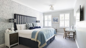A bedroom with a bed, bedside table, chair, desk, and a window. - The Fowey (Fowey)