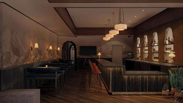 Un espace bar avec des comptoirs en bois, des tabourets et des luminaires suspendus.