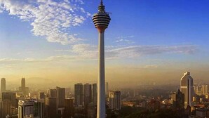 A tall tower with a distinctive design, surrounded by a cityscape with various buildings. - ARK Hotel Batu Caves (Batu Caves)