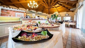 A buffet area with various dishes and a wooden ceiling. - TH San Teodoro Liscia Eldi Village (San Teodoro)
