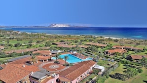 A resort with a large swimming pool, multiple buildings, and a view of the ocean. - TH San Teodoro Liscia Eldi Village (San Teodoro)