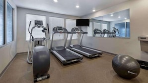 A gym with treadmills, an elliptical, and a stationary bike. - Woodspring Suites Riverside Norco (Norco)