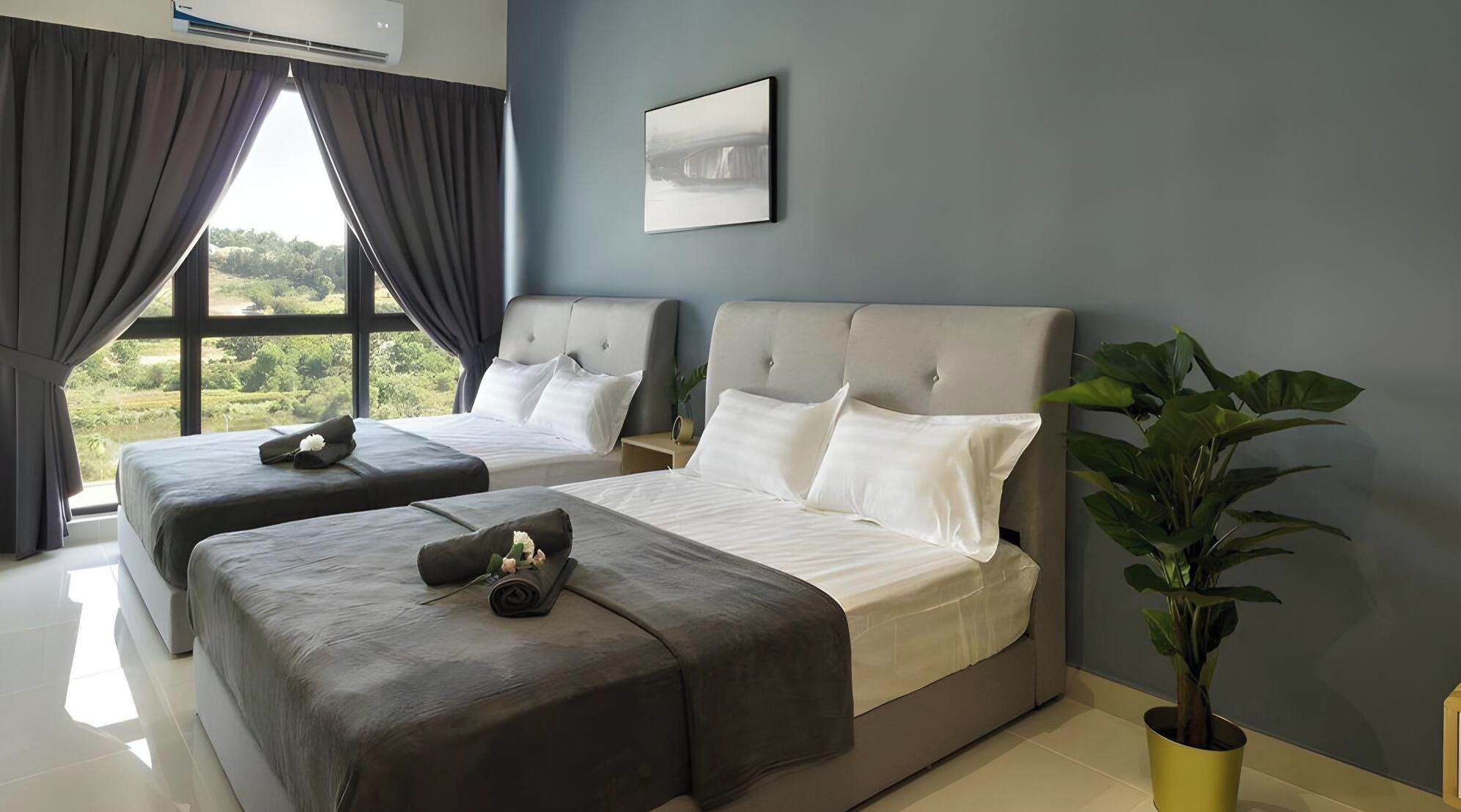 A hotel room with two beds, a large window with curtains, a potted plant, and a wall-mounted air conditioner.
