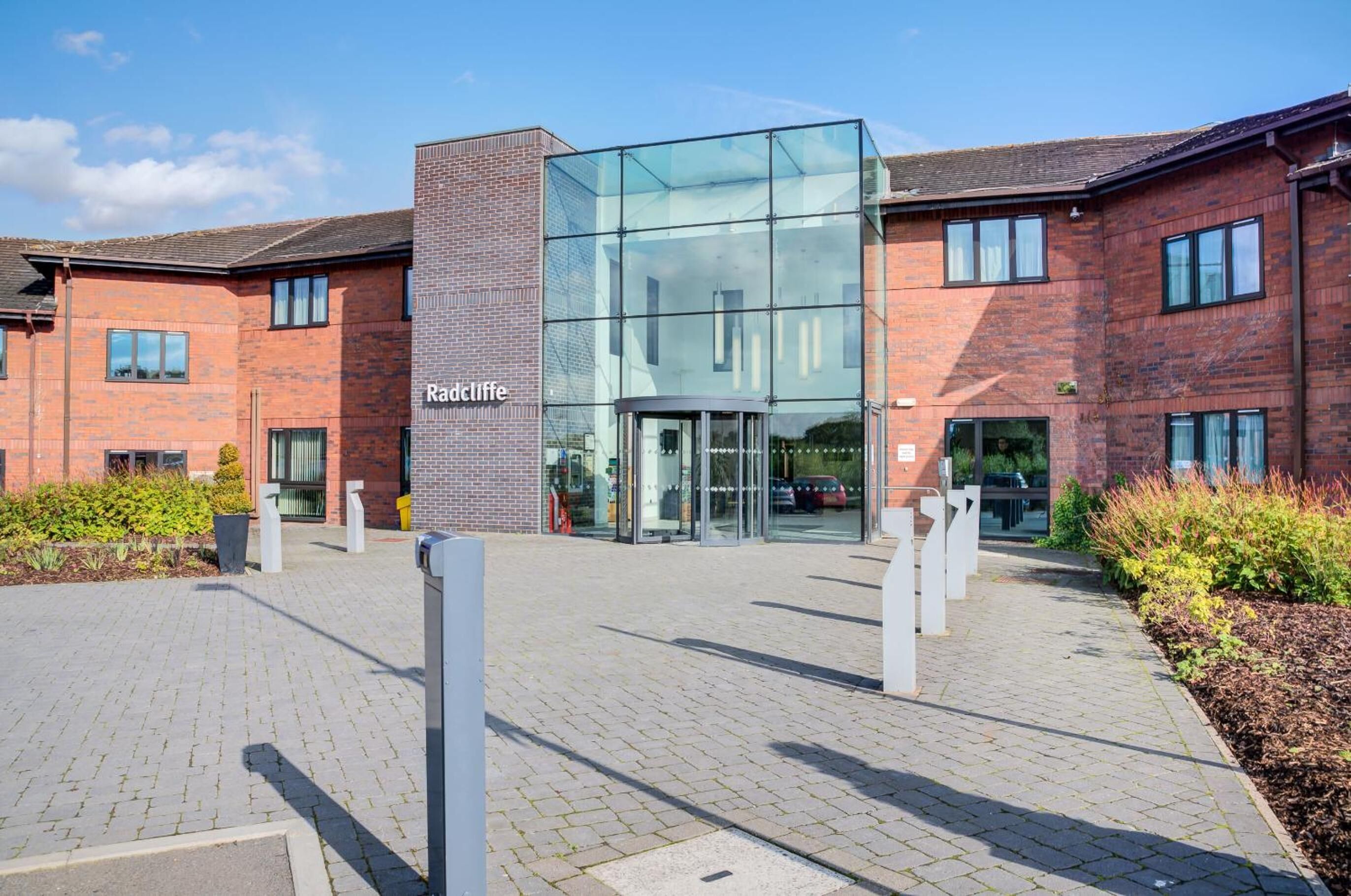 A modern building with a glass entrance and a brick facade.