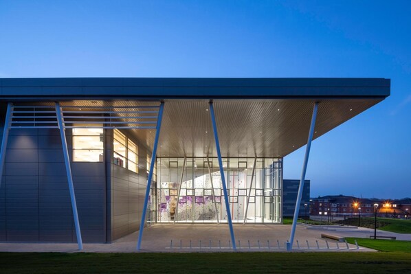 A modern building with a large glass facade and a covered entrance area. - Warwick Conferences - Radcliffe House (Coventry)