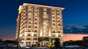 A multi-story hotel with a classic architectural style, featuring numerous windows and balconies. - Mare Hotel (Apokoronas)