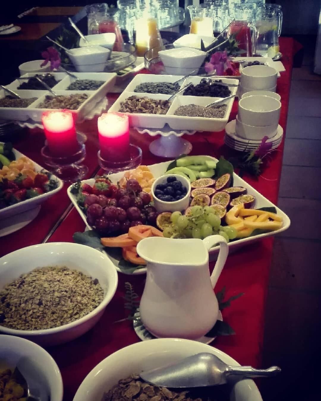 A buffet table with various food items and a pitcher of juice.