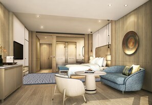 A modern hotel room with a bed, sofa, dining table, and a TV. - City of Dreams Mediterranean (Limassol)