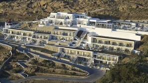 A modern multi-story hotel with a rooftop pool, terraced balconies, and a landscaped garden. - Once in Mykonos Luxury Resort - Designed for Adults (Mykonos)