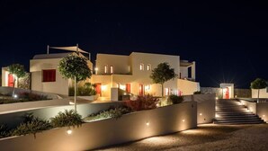 A modern multi-story building with a staircase leading to the entrance, surrounded by landscaped areas. - 11:11 By Potnia Theron - Adults Only (Santorini)