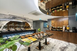 A buffet area with various food items, a coffee station, and a plant. - Nex Hotel Istanbul City Center (Istanbul)