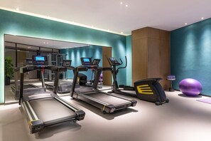 A modern gym with multiple treadmills, elliptical machines, and a large purple exercise ball. - Mercure Kunshan Mixc Hi-tech (Suzhou)