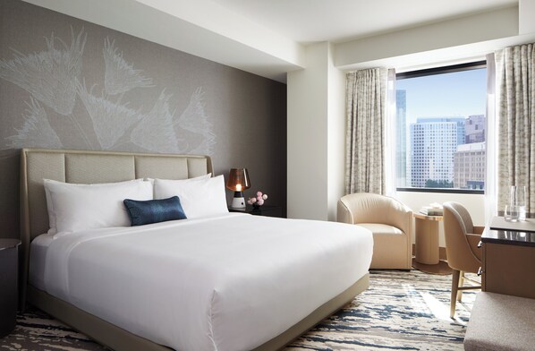 A hotel room with a large bed, a desk, a chair, and a view of the city through the window. - Intercontinental Bellevue at the Avenue (Bellevue)